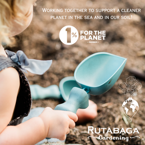 A small girl holding a Rutabaga Garden Tool scoop.
