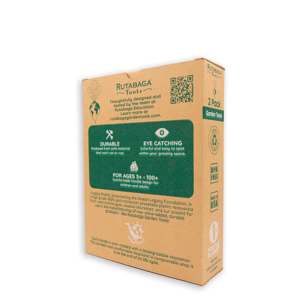 A photo of Rutabaga Garden Tool trowel and hand rake in the packaging box that is made of cardboard with green detail. This photo shows the tools and the back side of the box.