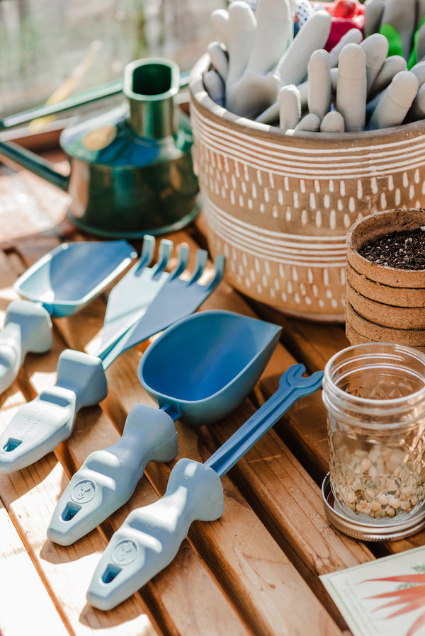Rutabaga Garden Tools sitting on a garden table surrounded by gardening supplies.