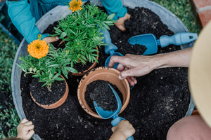 Adults and children planting flowers with Rutabaga Garden Tools.