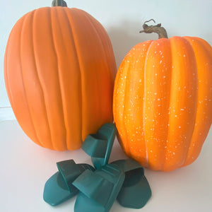 Two large pumpkins and a pile of four Pumpkin Scraper Tools.
