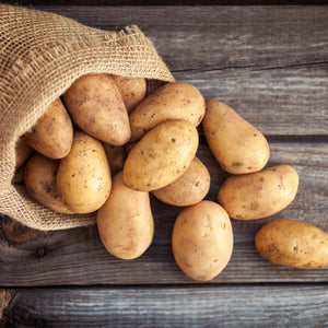 A photo of potatoes in a sack.