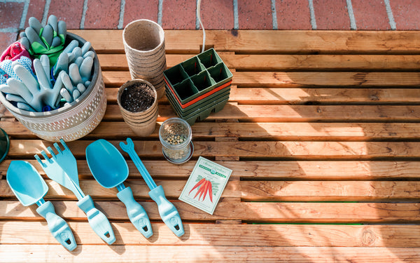 Rutabaga Garden Tools sitting on a garden table surrounded by gardening supplies.