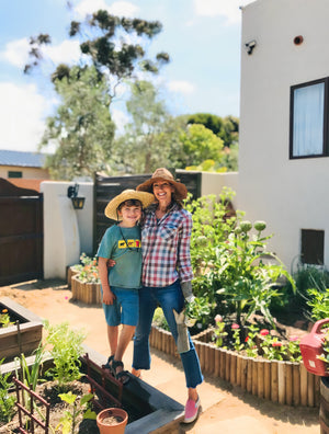 A woman and her son in the garden.